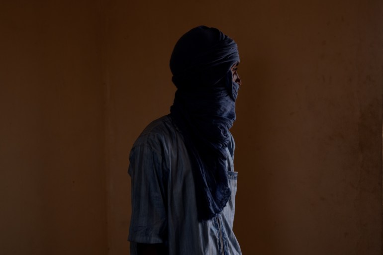 Ag poses for a portrait in an office in Mbera camp recalling his journey fleeing violence in Mali 