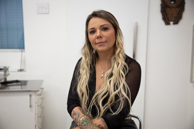 Brazilian tattoo artist Karlla Mendes poses for a photo