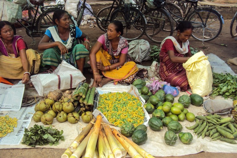 Women selling their foraged vegetables in the market