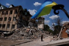 Press officer Olexii Mischenko shows a destroyed city administration building in Bashtanka, Mykolaiv region