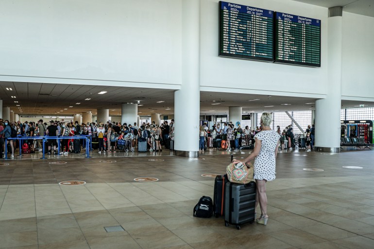 British people gather at Faro Airport as they interrupt their holidays in the Algarve to return home due to the British government's new quarantine rules about the COVID-19 pandemic, in Faro, Portugal