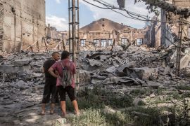 Locals look at destroyed buildings in Lysychansk, Ukraine.