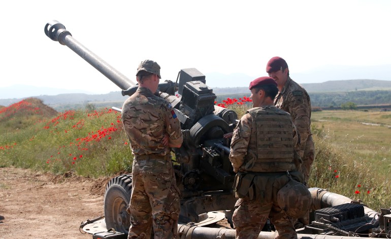 British soldiers from the 16 Air Assault Brigade stand next to a howitzer during the Swift Response 22 military exercise at the Krivolak army training polygon in the central part of North Macedonia