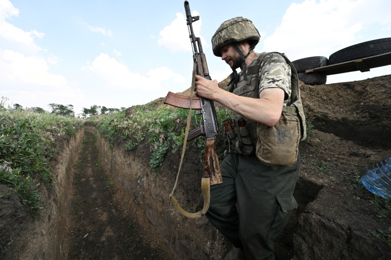 A Ukrainian serviceman Petro, 32, walks in a trench on a position held by the Ukrainian army between southern cities of Mykolaiv and Kherson on June 12, 2022, amid the Russian invasion of Ukraine. 