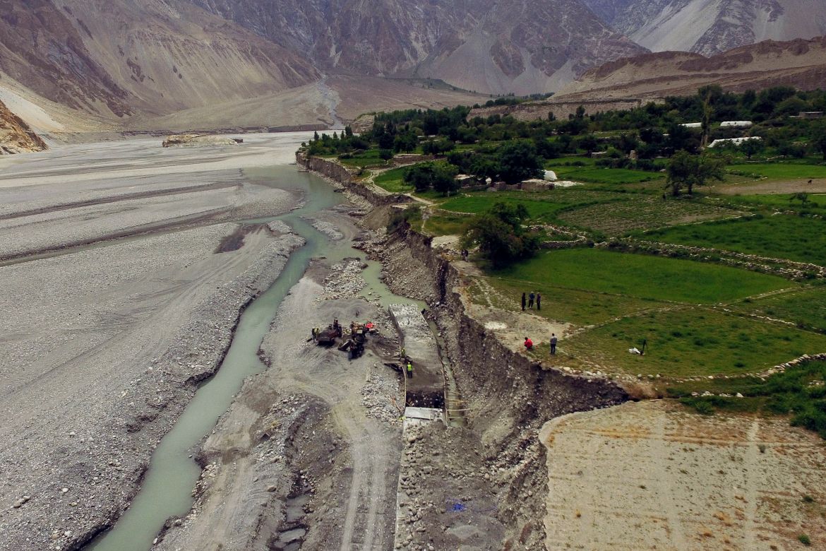 In this aerial picture taken on June 10, 2022, engineers and construction workers built a concrete wall to protect Passu village from land erosion