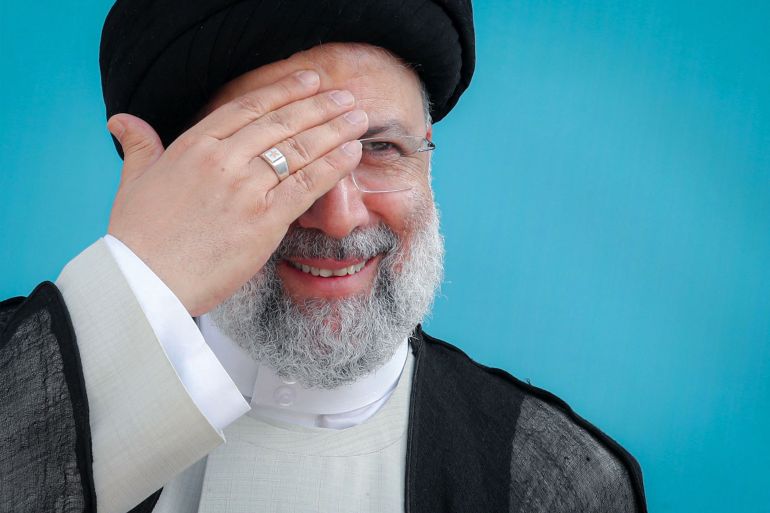 Iran's President Ebrahim Raisi greeting supporters during a rally in the western city of Kermanshah on July 14 2022 [Iranian Presidency/AFP]