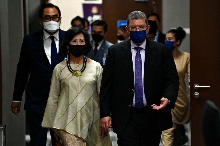 UN special envoy on Myanmar Noeleen Heyzer walks with Malaysian foreign minister Saifuddin Abdullah in Malaysia's parliament.