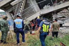 A rescue team at the site of a collapsed building in La Trinidad
