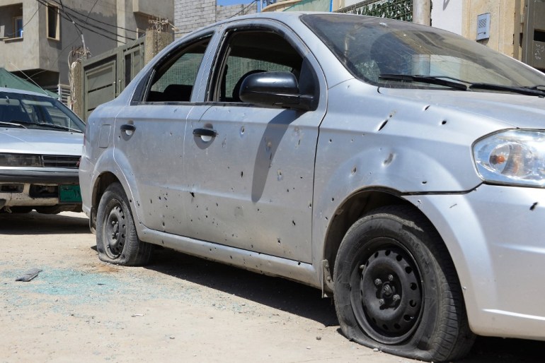 A shrapnel riddled car stands in the area of the Turkish consulate in the northern Iraqi city of Mosul 