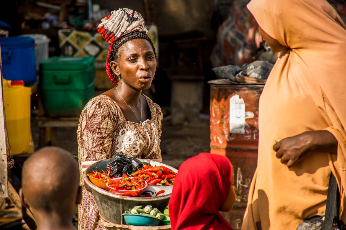 In this photo, a woman negotiates prices for her fresh produce. Women in Informal Cross-Border Trade (or WICBT) is a common term used within the international development community to describe strategies for gradually building women microbusinesses into dynamic enterprises, and not simply businesses that barely sustain their livelihoods. However, the lack of investors, trade associations, and adequate infrastructure to permit sustainable growth limits the impact WICBT initiatives can have.