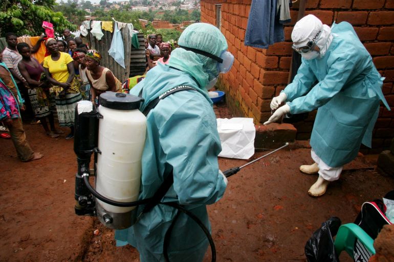 World Health Organisation officials examine the home of a suspected Marburg virus victim in the northern Angolan town of Uige