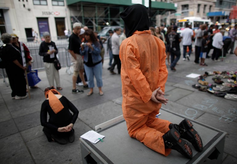 Mock detainee performance by artists in a New York City rally.