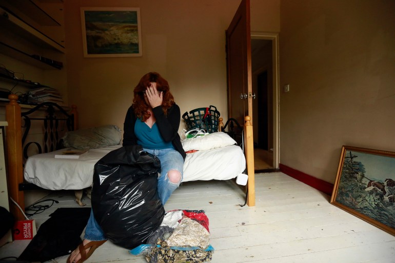 Ann Cronin reacts as she packs her belongings in preparation for her family's emigration from her hometown of Ennis in County Clare, to New Zealand September 27, 2013. Picture taken September 27. To match Insight IRELAND-BAILOUT/  REUTERS/Cathal McNaughton (IRELAND - Tags: SOCIETY IMMIGRATION BUSINESS EMPLOYMENT)