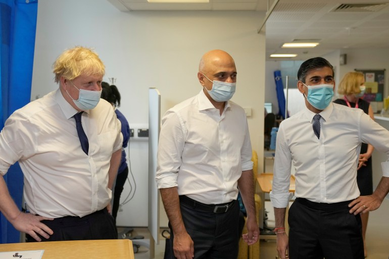 British Prime Minister Boris Johnson, Health Secretary Sajid Javid and Chancellor of the Exchequer Rishi Sunak stand during a visit to the New Queen Elizabeth II Hospital, in Welwyn Garden City, Britain, April 6, 2022. Frank Augstein/Pool via REUTERS