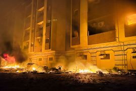 A view shows fire burning inside the Libyan parliament building after protests against the failure of the government, in Tobruk