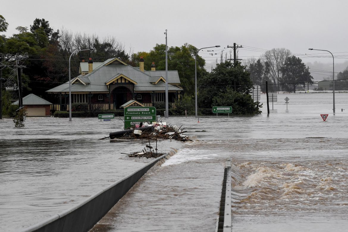 Debris is seen as the Windsor Bridge is submerged under floodwater from the swollen Hawkesbury River in Windsor