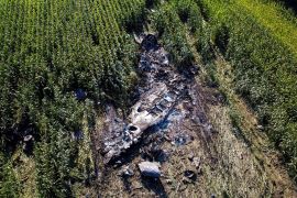 Debris is seen at the crash site of an Antonov An-12 cargo plane