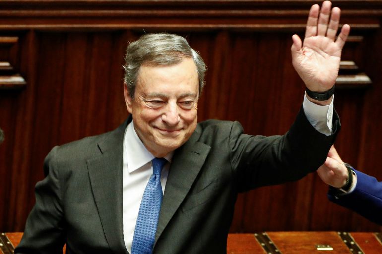 Italy's Prime Minister Mario Draghi waves as he leaves after addressing the lower house of parliament ahead of a vote of confidence for the government.