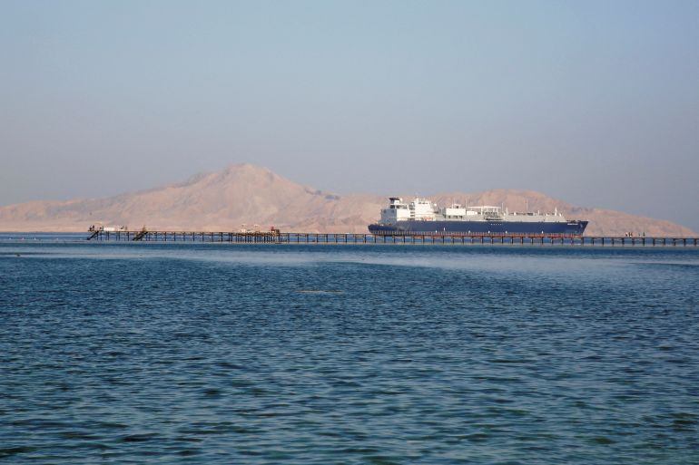A container ship passes in front of Tiran Island