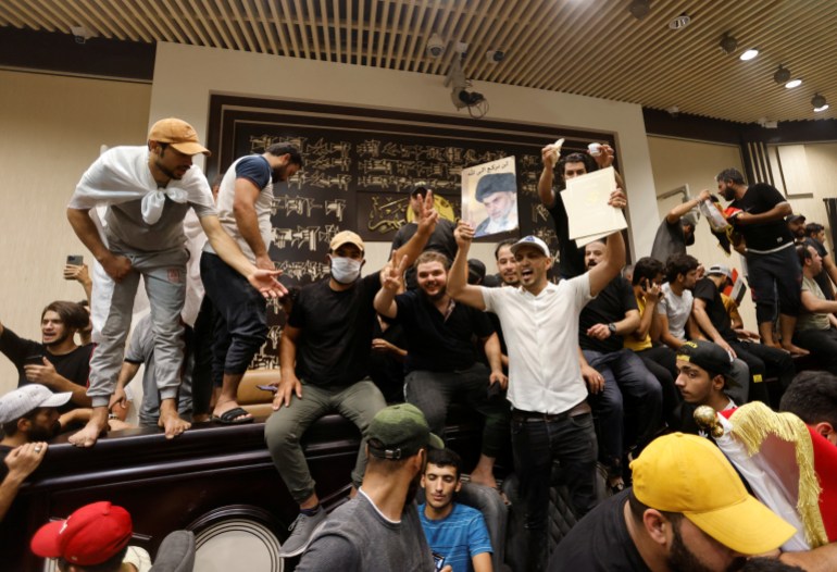 Supporters of Iraqi Shi'ite cleric Moqtada al-Sadr protest against corruption inside the parliament building in Baghdad