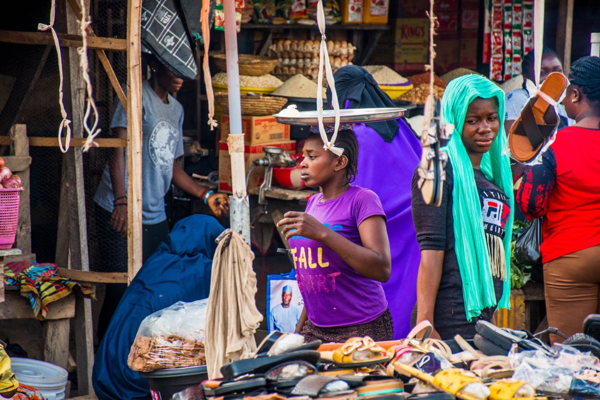The UN has committed $1.1 billion USD in humanitarian aid for the region, but lower employment rates persist for women in Northern Nigeria compared to women in the rest of the country. Here, several women are pictured selling various goods in Minna’s central market.