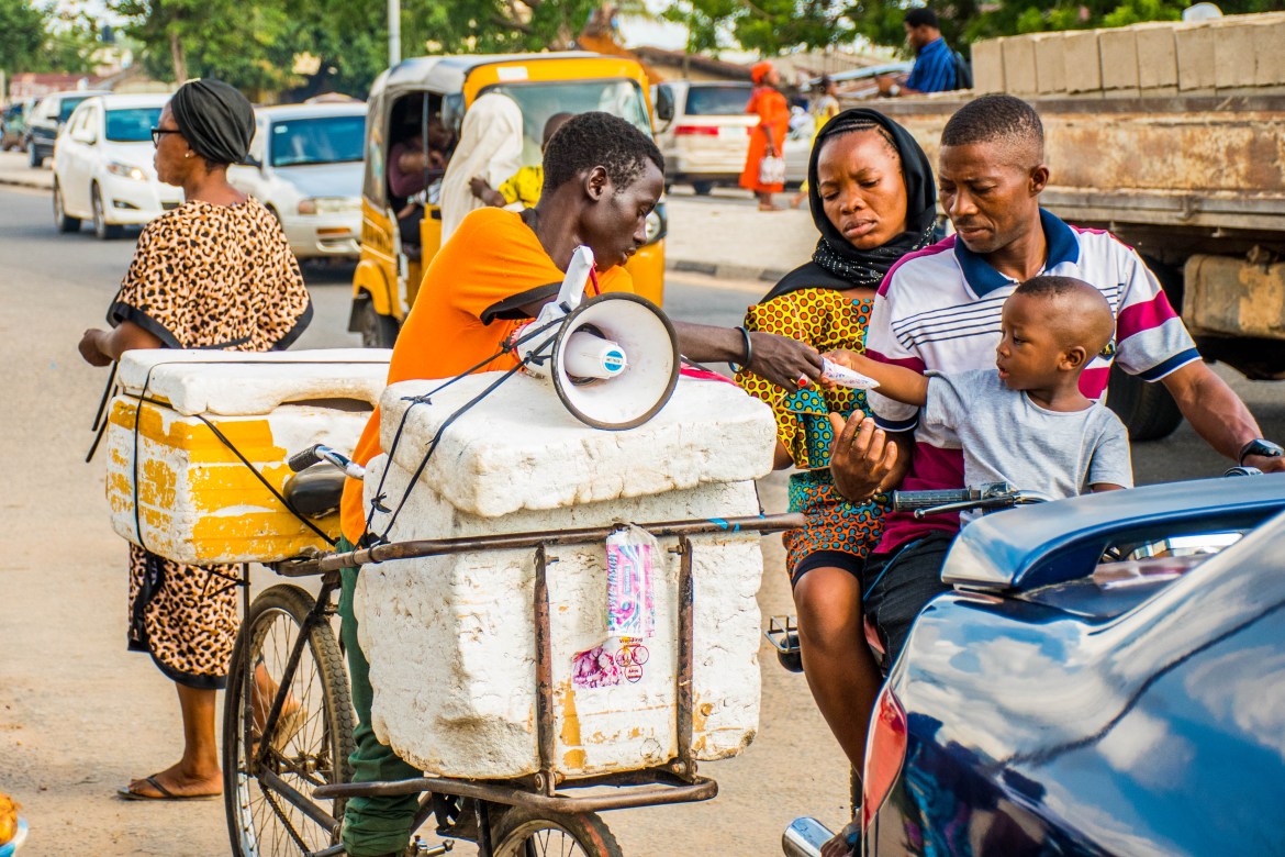 A male vendor sells items on his bike in Minna, Nigeria. The UK Department for International Development found that Nigeria still hasn’t achieved gender parity in relation to employment. Even with the fastest-growing rate of any group starting businesses, Nigerian women (in both formal and informal sectors) are less likely to earn a livable wage compared to their male counterparts.