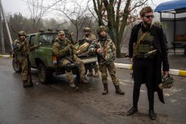 Sviatoslav Yurash, 26, member of the Ukrainian parliament, stands with his territorial defence unit in the outskirts of Kyiv