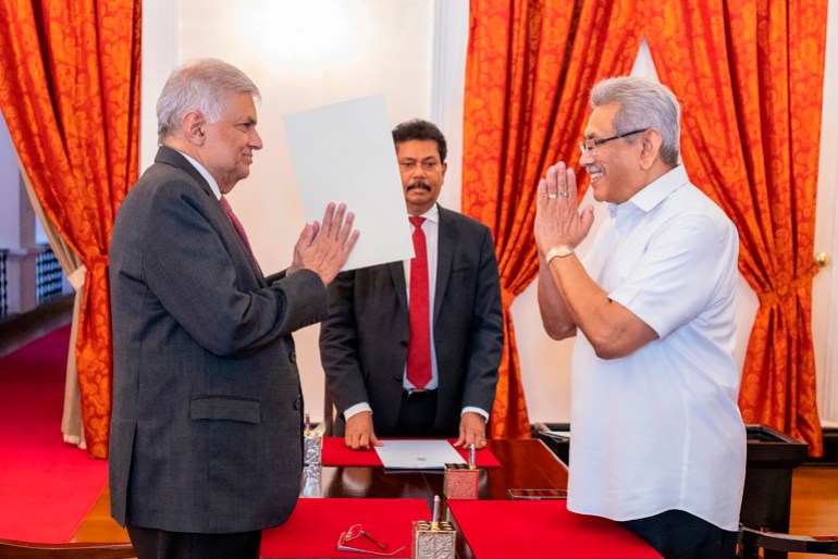 Sri Lankan President's Office, President Gotabaya Rajapaksa, right, greets prime minister Ranil Wickremesinghe during the latter's oath taking ceremony