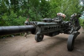 Ukrainian soldiers move a U.S.-supplied M777 howitzer into position to fire at Russian positions in Ukraine's eastern Donetsk region