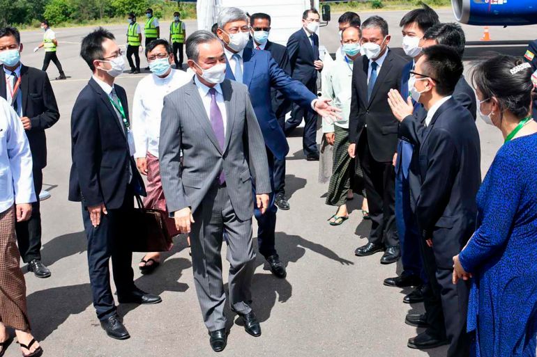 Chinese Foreign Minister Wang Yi, centre, is welcomed by Myanmar Foreign Ministry representatives and Chinese embassy officials upon his arrival at Nyaung Oo Airport in Bagan, Myanmar