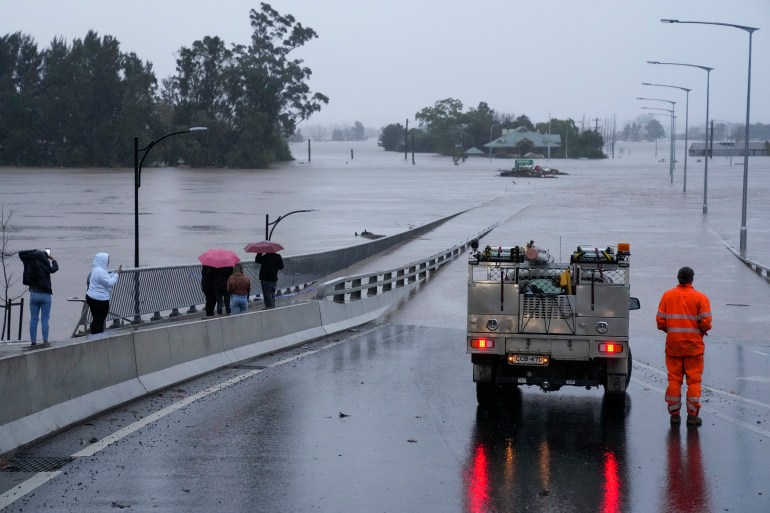 An emergency vehicle blocks access to the flooded Windsor Bridge on the outskirts of Sydney, Australia.