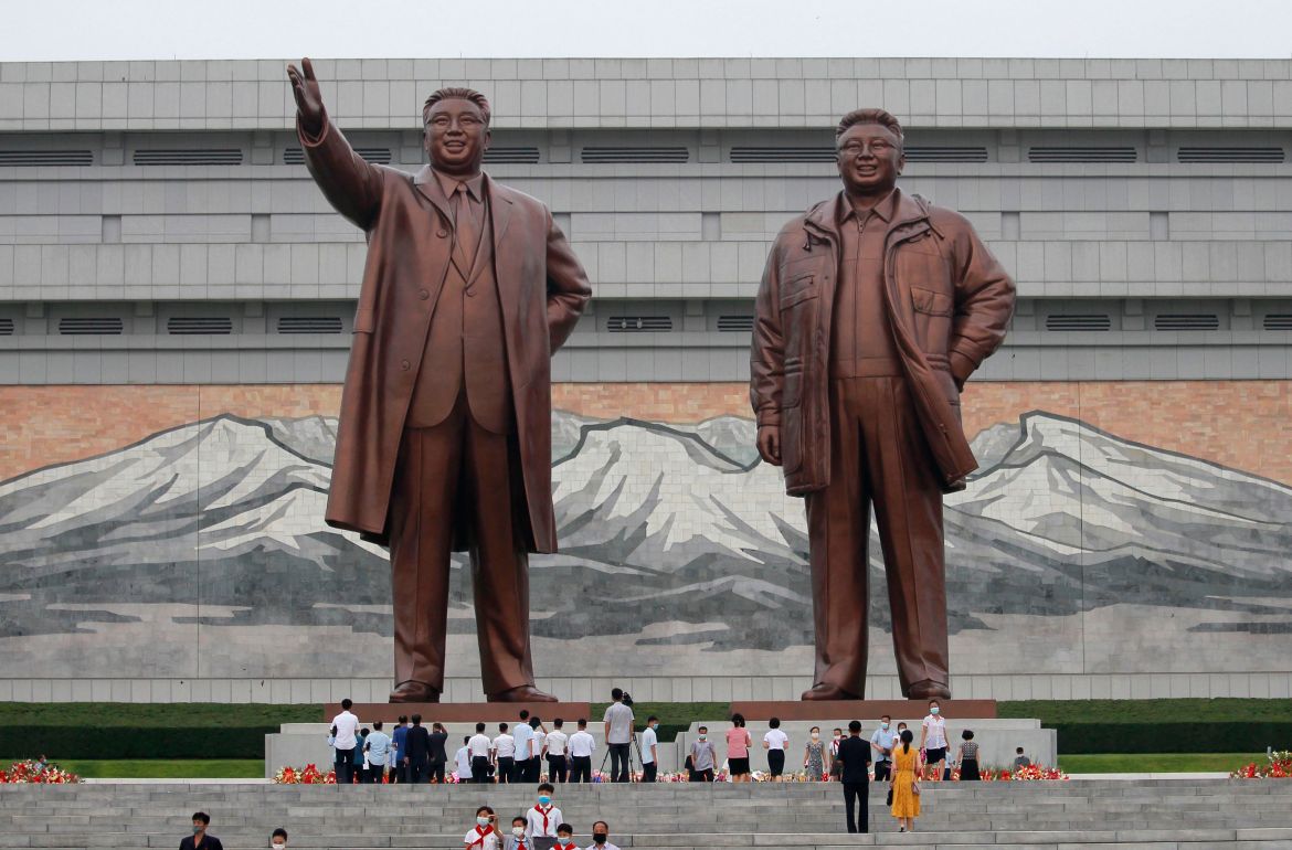 People visit the statues of former North Korean leaders Kim Il Sung and Kim Jong Il