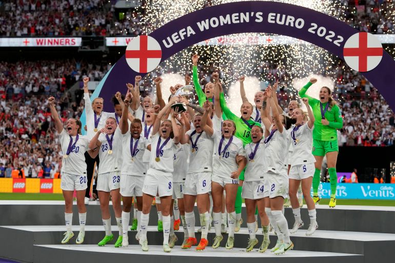 England's Leah Williamson, center left, and Millie Bright lift the trophy after winning the Women's Euro 2022 final soccer match between England and Germany at Wembley stadium in London, Sunday, July 31, 2022. England won 2-1. (AP Photo/Alessandra Tarantino)