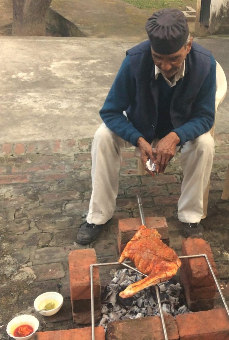 Majid Bhai watching the raan kabab on the makeshift brick barbecue