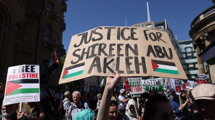 Demonstrators hold placards during the Free Palestine, End Apartheid protest outside BBC Broadcasting House May 14, 2022 in London, England.