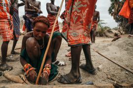 Herders gather at a watering hole in Kenya