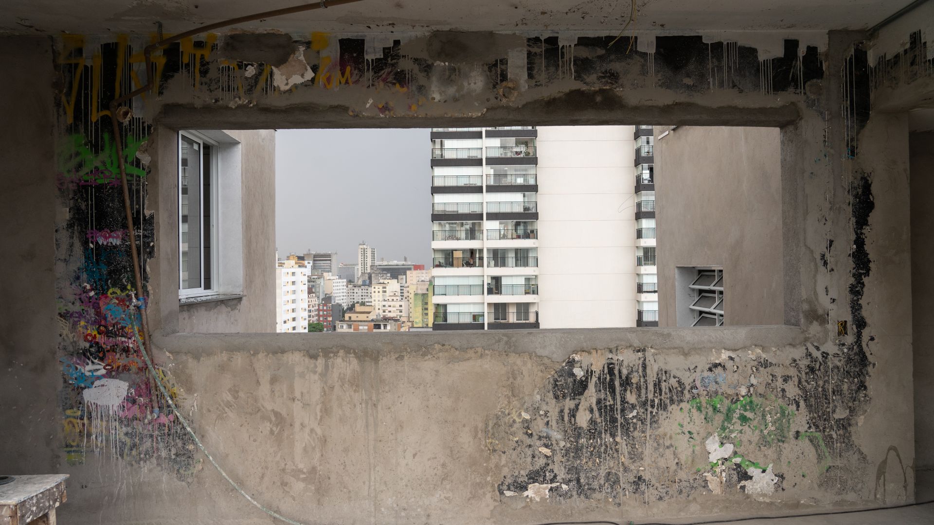 Remnants of graffiti painted during the occupation are seen against the backdrop of the city