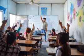 A teacher and school children in a classroom in Mosul