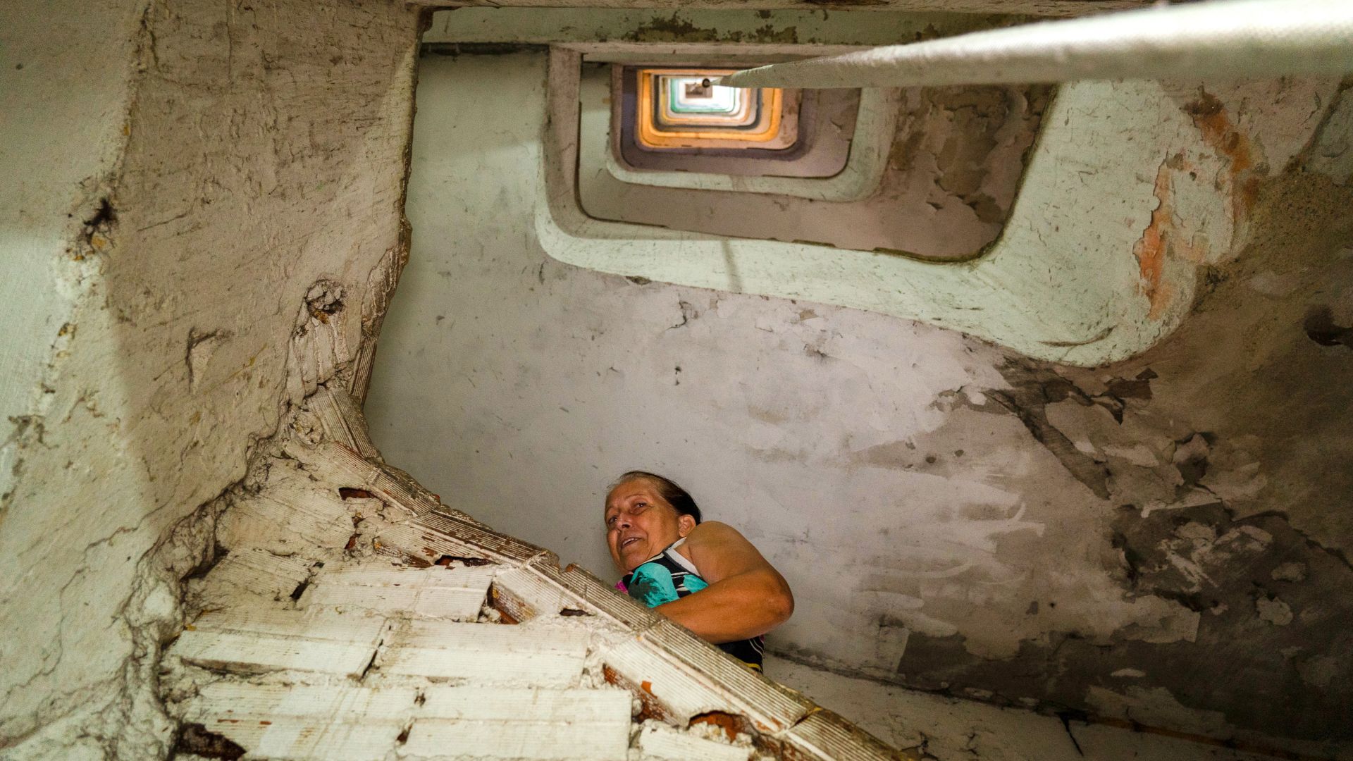 A resident is seen climbing the stairs of the 21-story high building.