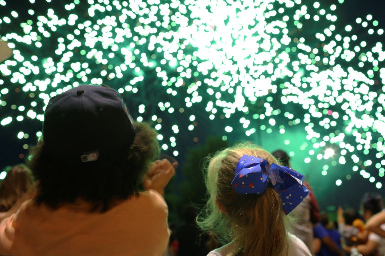 Kids watch an Independence Day, Fourth of July, fireworks display in Somerville, Massachusetts