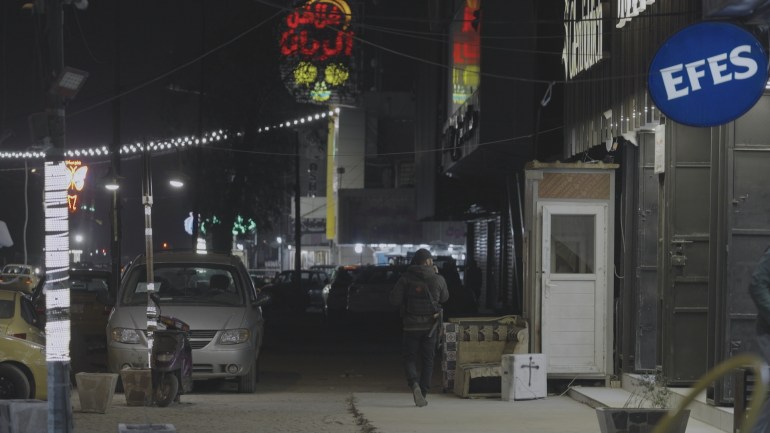 An armed guard stands on the street in Bataween, Baghdad's red-light district