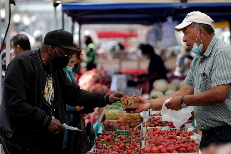 A resident buys strawberries at a local market, in downtown San Francisco, California, U.S