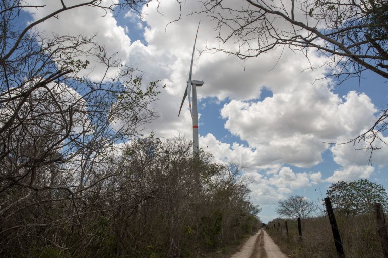 A wind turbine stands near a road in the town of Dzilam de Bravo near Merida, Yucatan, Mexico