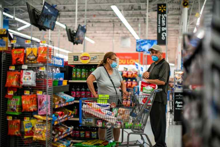 Shoppers are seen wearing masks while shopping at a Walmart store, in North Brunswick, New Jersey, US