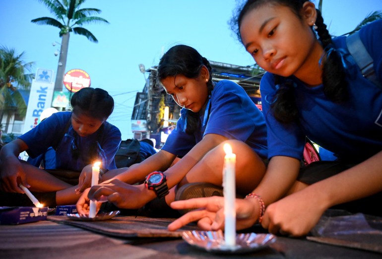 Schoolchildren light candles during a memorial service for the victims of the 2002 Bali bombings 
