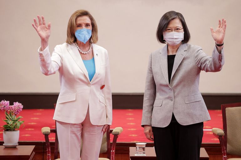 This handout taken and released by Taiwan's Presidential Office on August 3, 2022 shows US House Speaker Nancy Pelosi (L) waving beside Taiwan's President Tsai Ing-wen at the Presidential Office in Taipei.