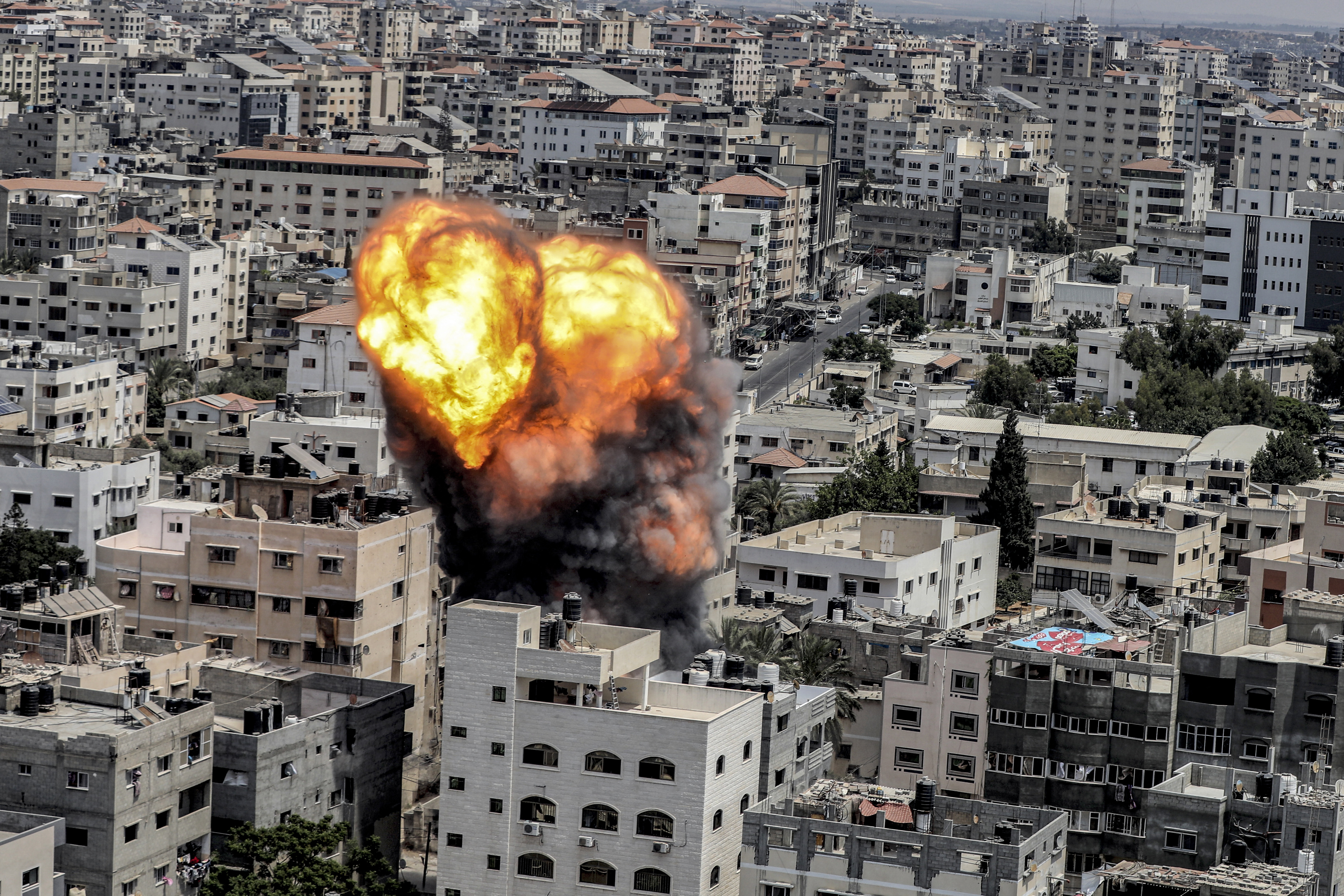 A fireball erupts as a result of an Israeli air strike on a building in Gaza City