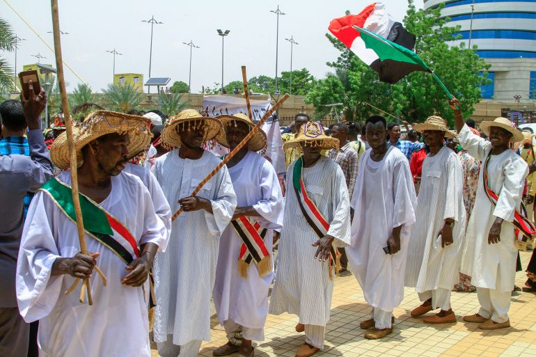 Sudanese demonstrators rally outside the Al-Sadaka hall in Khartoum in support of "The Call of Sudan's People" political initiative.