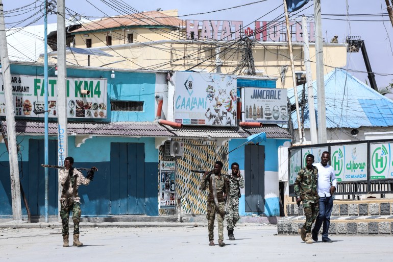 Security officers patrol near the the site of explosions in Mogadishu on August 20, 2022
