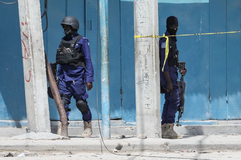 Security officers patrol at the the site of explosions in Mogadishu on August 20, 2022